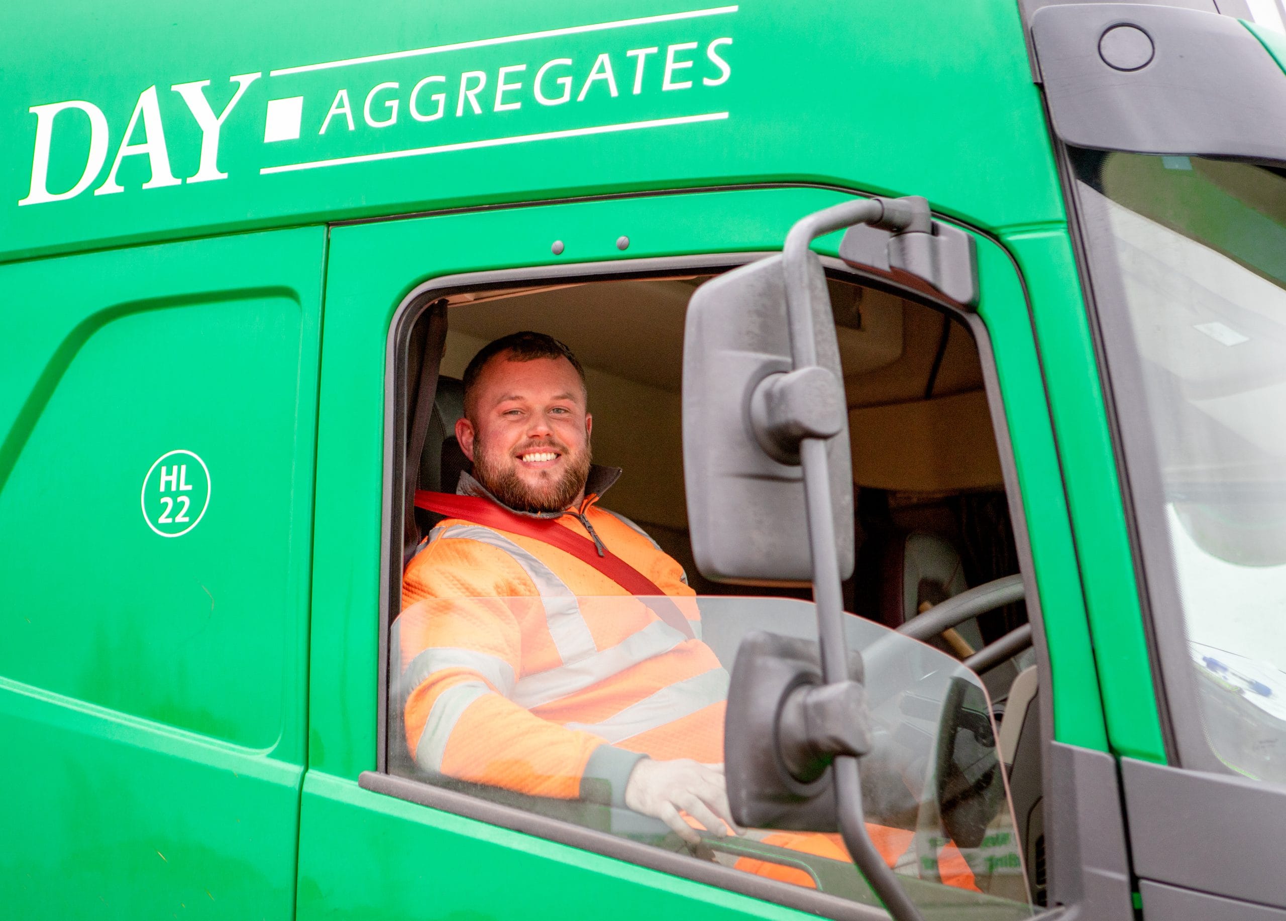 Smiling employee in Day Aggregates truck.