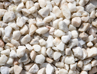 White chippings, graded from 10 to 20mm, containing brilliant white limestone, displayed loose.