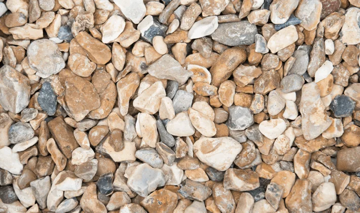 Shingle, a natural flint aggregate, graded from 10mm to 20mm, displayed dry.