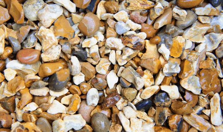 Golden shingle, displayed wet, containing golden, brown and white flints, graded from 10 to 20mm.