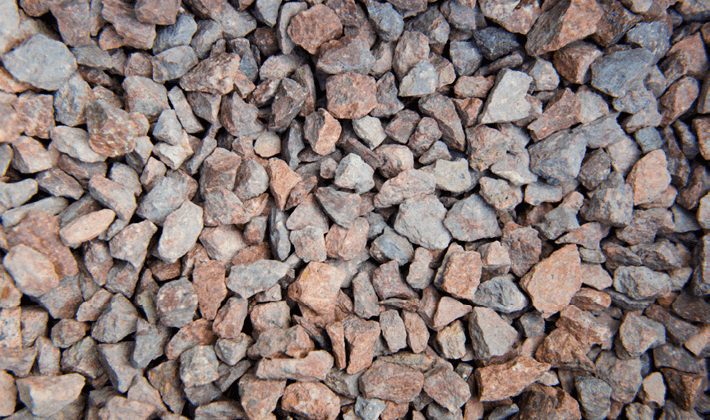 Red chippings, graded from 6 to 14mm, containing angular, red granite stones, displayed dry.