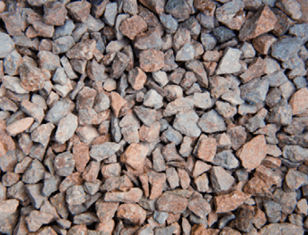 Red chippings, graded from 6 to 14mm, containing angular, red granite stones, displayed loose.