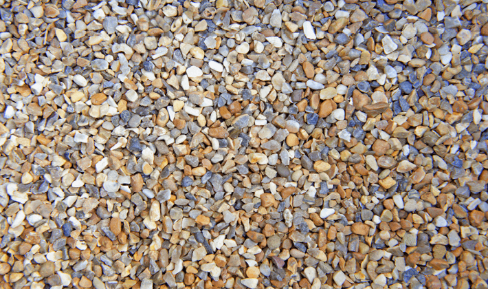 Shingle, containing fine, golden, grey & brown gravel, graded from 2mm to 6mm, displayed dry.