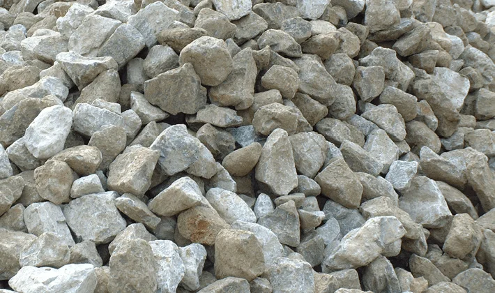Gabion stone, containing irregularly shaped limestone, granite and ragstone rocks between 50mm and 200mm, displayed loose.