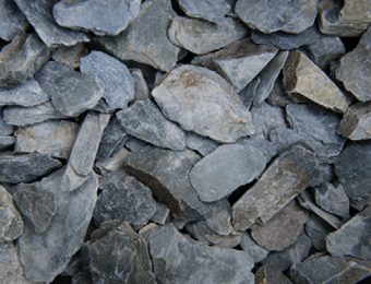 Green slate displayed loose, containing green, blue and grey chippings, graded from 30mm to 50mm.