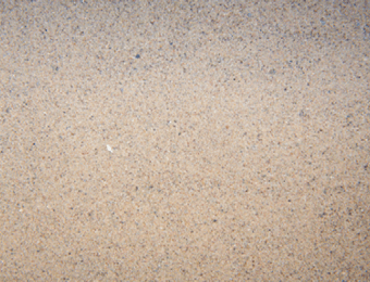 Sub-angular particles of kiln dried sand with varied colours, displayed loose.