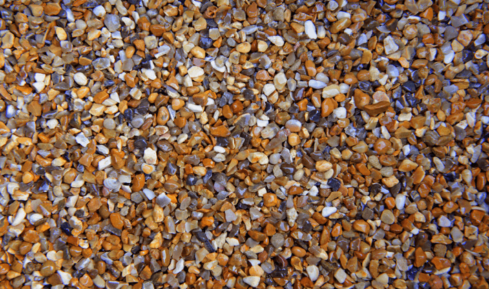Shingle, containing fine, golden, grey & brown gravel, graded from 2mm to 6mm, displayed wet.