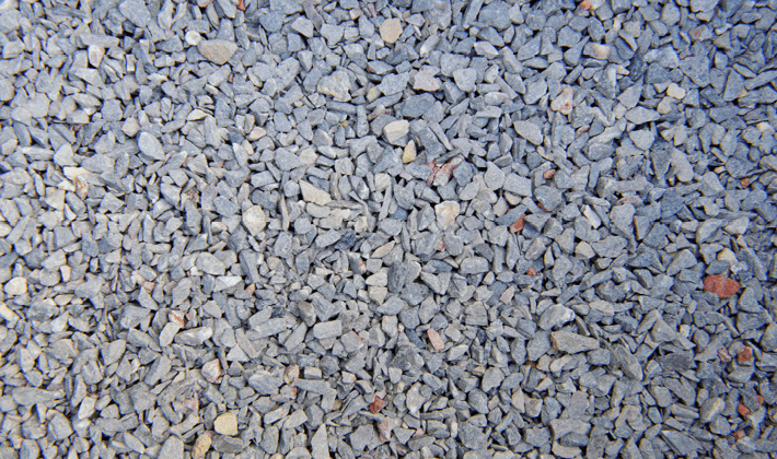 Cleanstone, containing quarried crushed limestone and granite, graded from 2mm to 6mm, displayed loose.