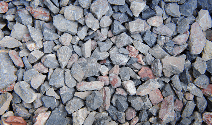 Cleanstone, containing quarried and crushed limestone, granite and ragstone, graded from 4mm to 20mm, displayed loose.