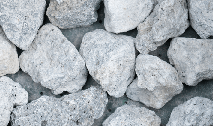 Loose display of blast furnace slag filter media, containing iron ore, limestone and coke.