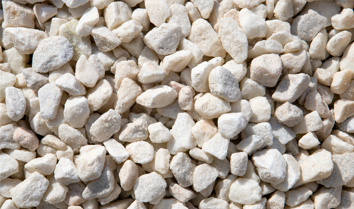 White chippings, graded from 10 to 20mm, containing brilliant white limestone, displayed dry.
