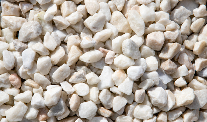 White chippings, graded from 10 to 20mm, containing brilliant white limestone, displayed wet.